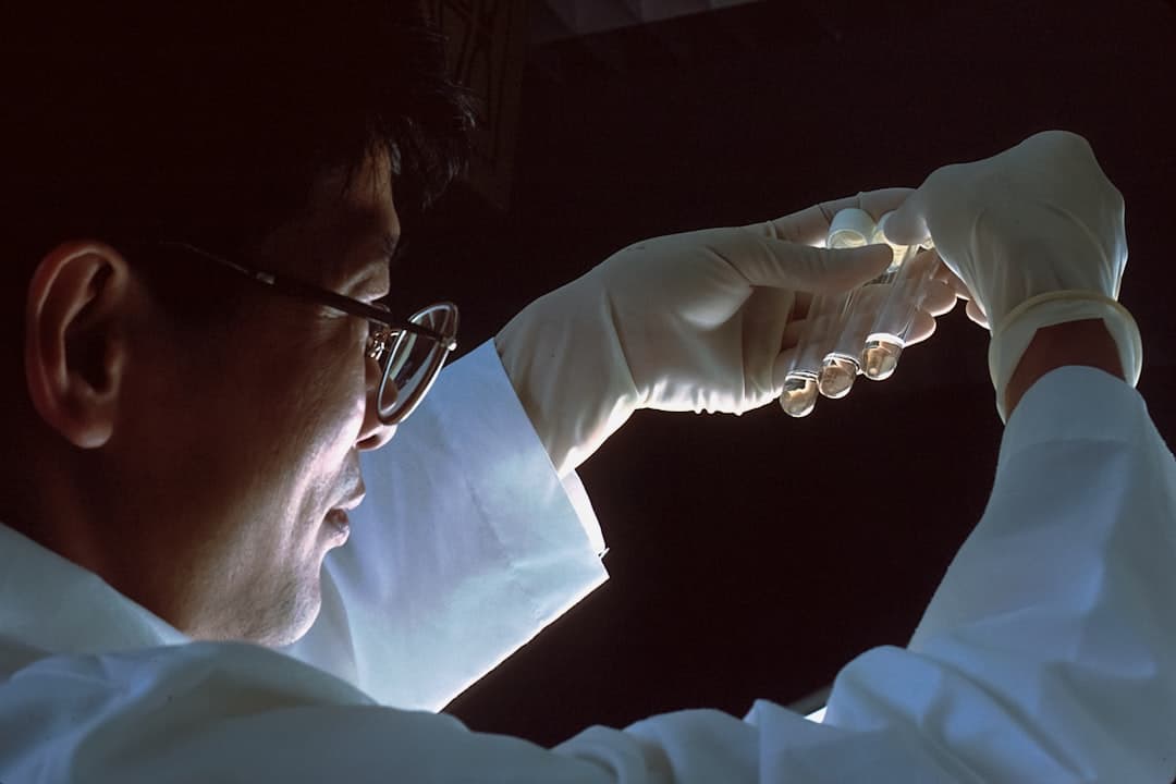 Environmental professional handling a sample vial