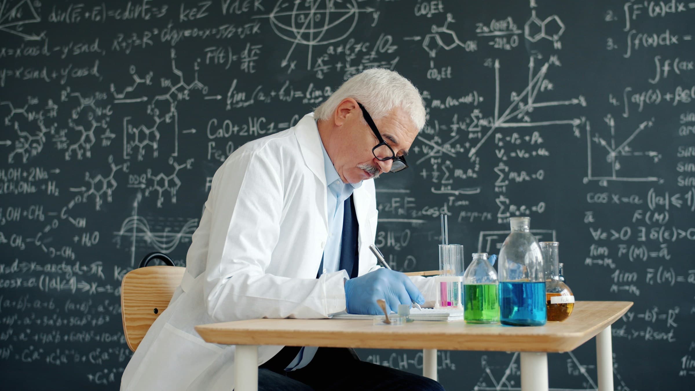 Scientist in lab coat documenting results at a lab bench