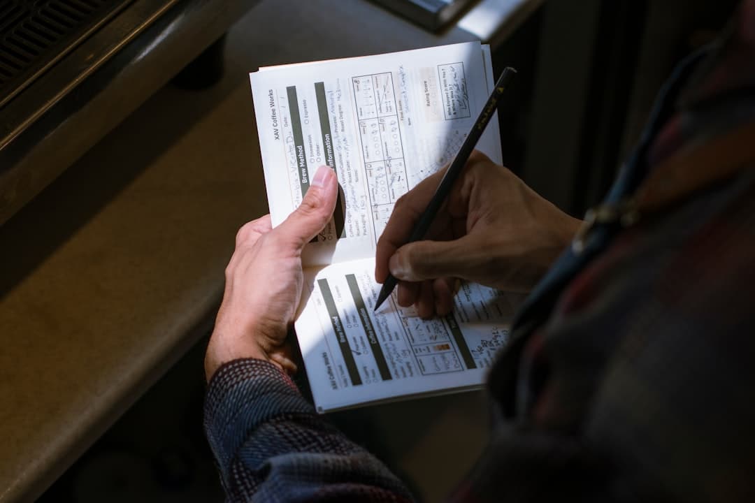 Person reviewing a receipt and notebook