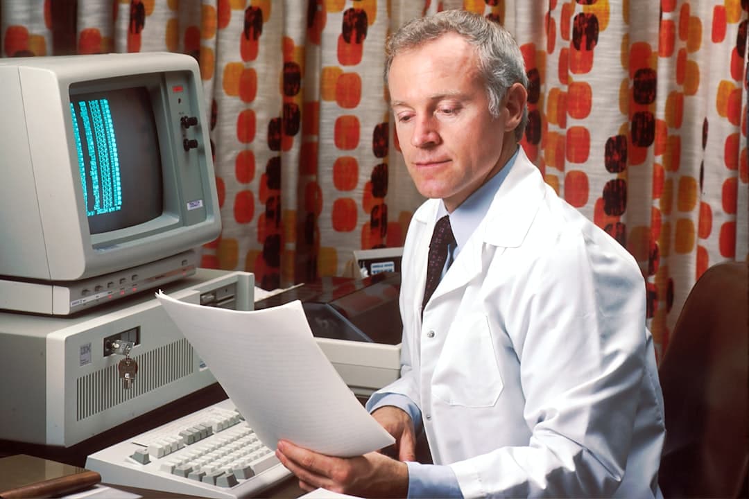 Lab analyst reviewing reports on a computer