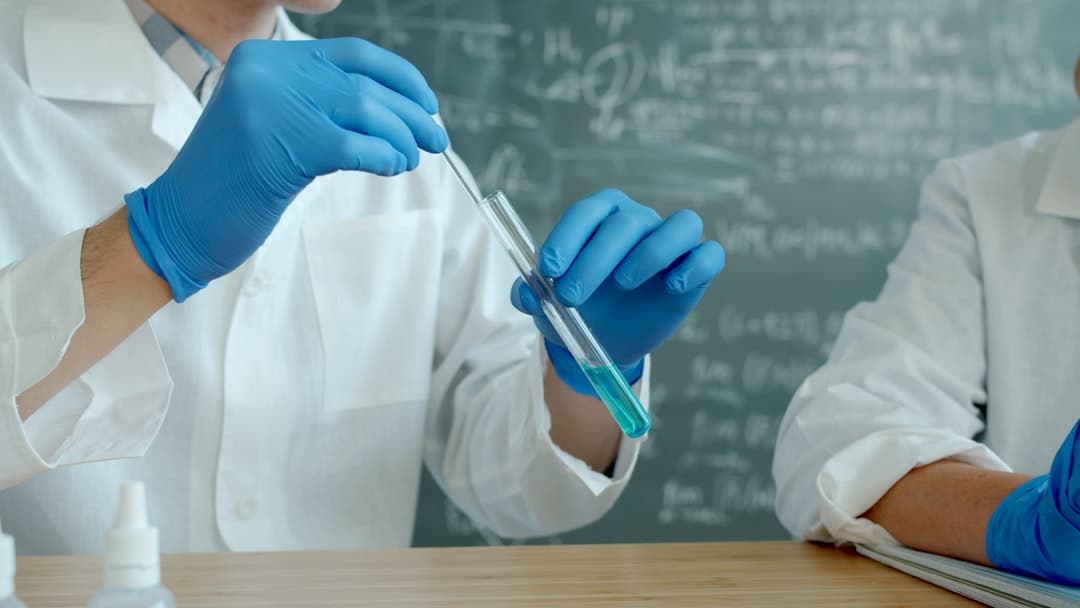 Analyst examining sample tubes