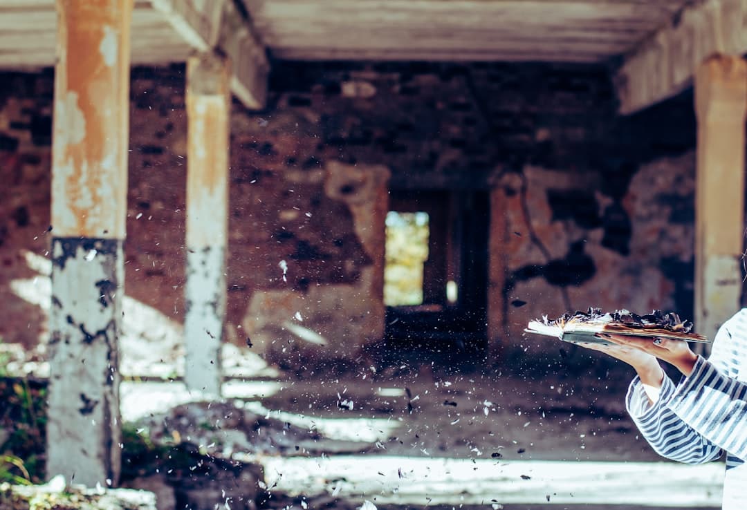 Adjuster inspecting building damage with a clipboard