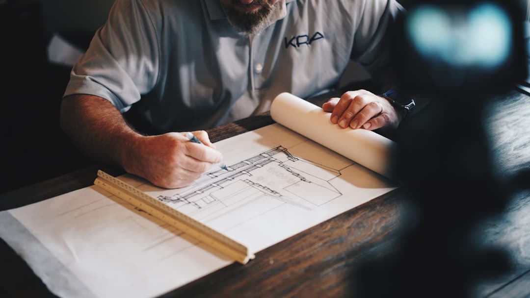 Contractor reviewing building plans on a job site
